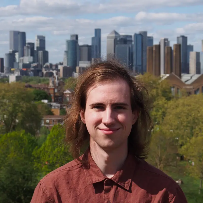 A headshot picture of me. The city of London is in the background.